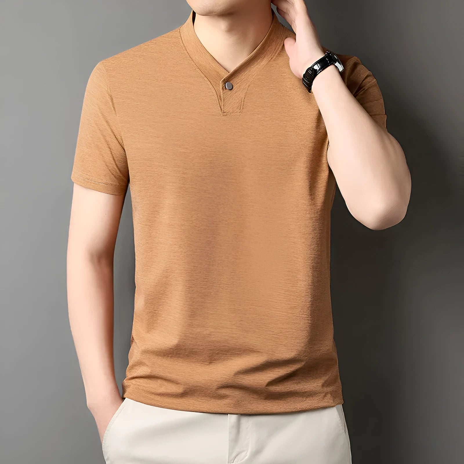 Young man wearing a short sleeve zip collar T-shirt in a casual setting.