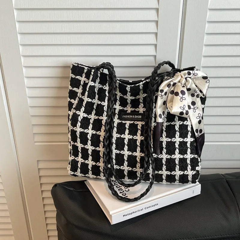 Black woolen shoulder bag with horizontal square shape showing internal organisation compartments