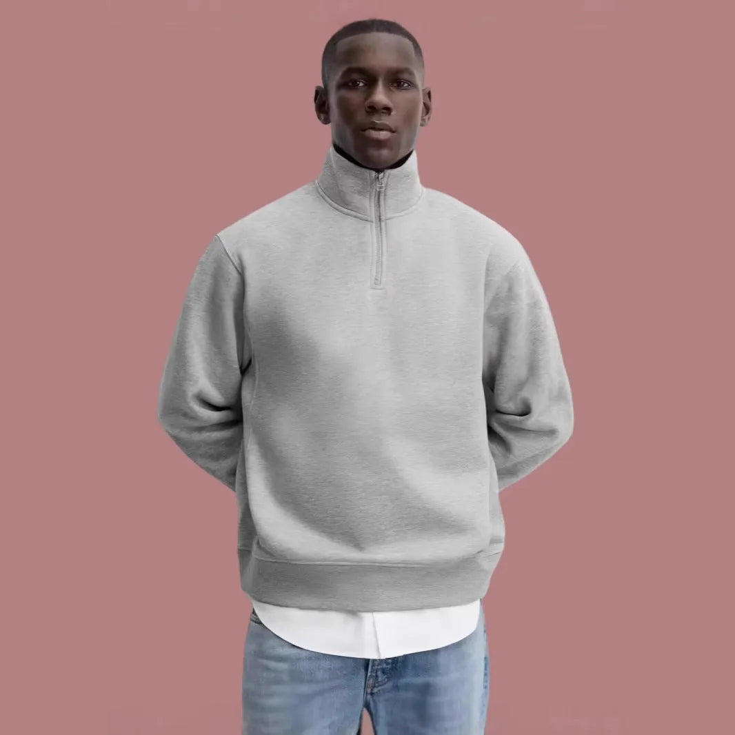 Half-zipped grey cotton sweatshirt with stand collar, long sleeves, and casual grunge style texture