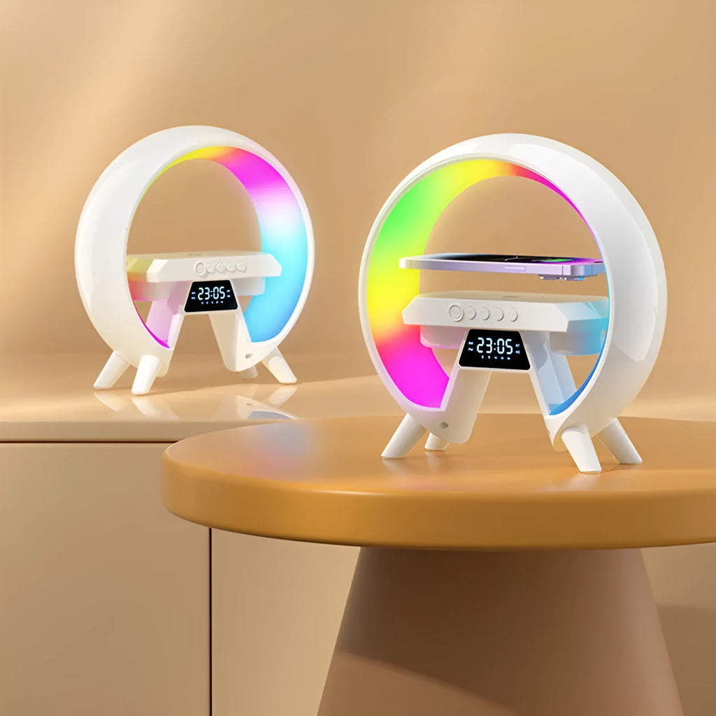 Black Bluetooth bedside speaker with wireless charging pad and LED clock display on white surface