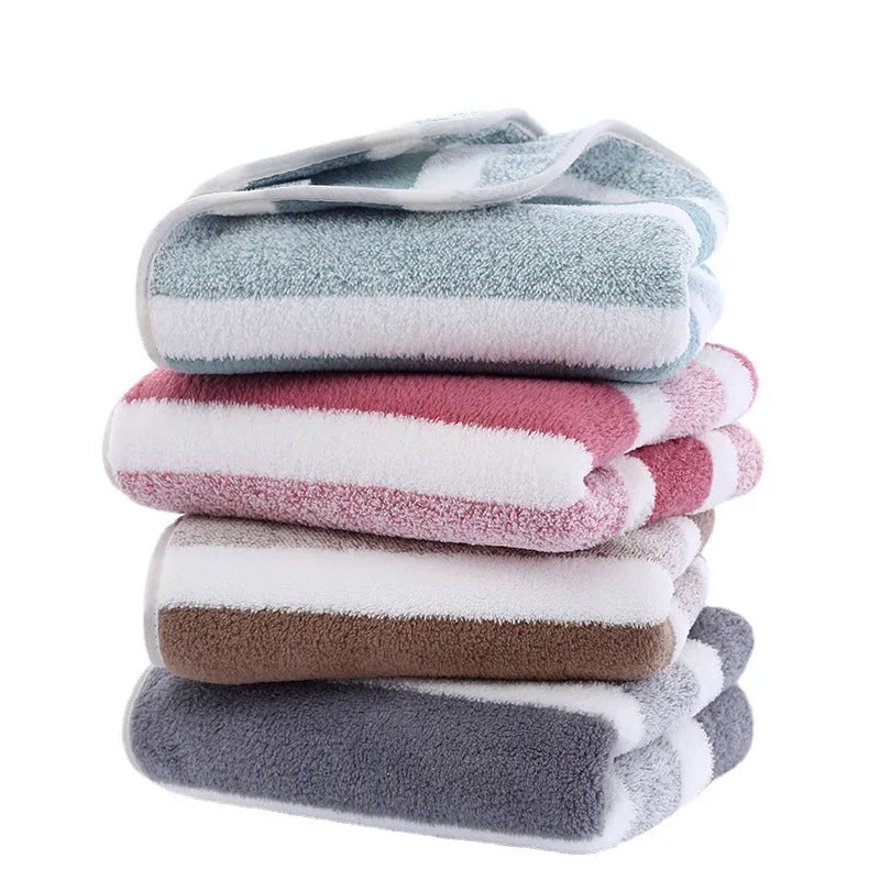 Coral fleece striped bath towel set showing hand towel and bath towel in grey and pink.