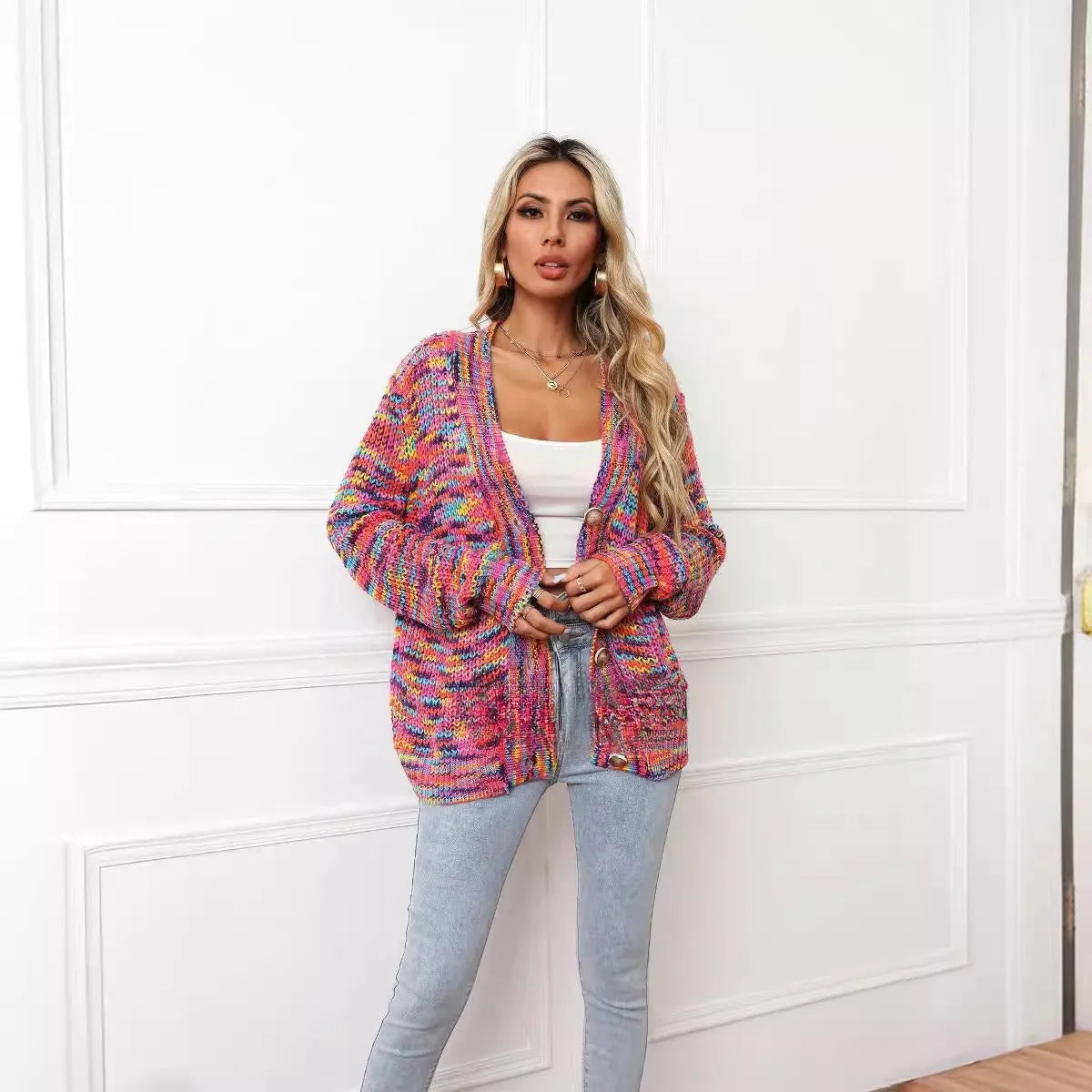 Rainbow striped loose fit knitted cardigan coat on a hanger, rose red with multicolour stripes.