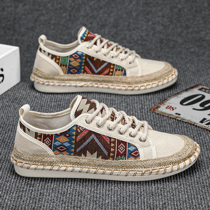 Men's round toe casual cloth shoes in beige and black on a plain background.