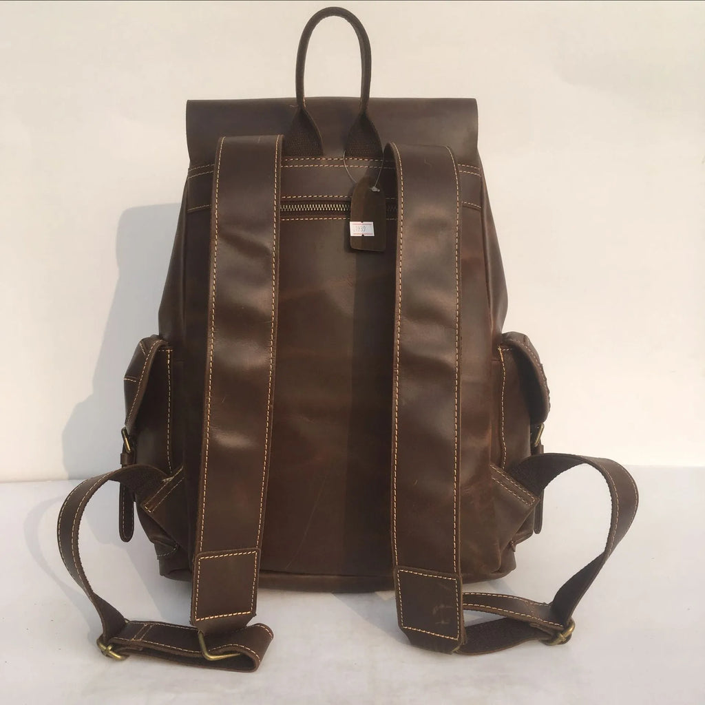 Brown men's genuine cowhide leather backpack with air pillow belt straps.