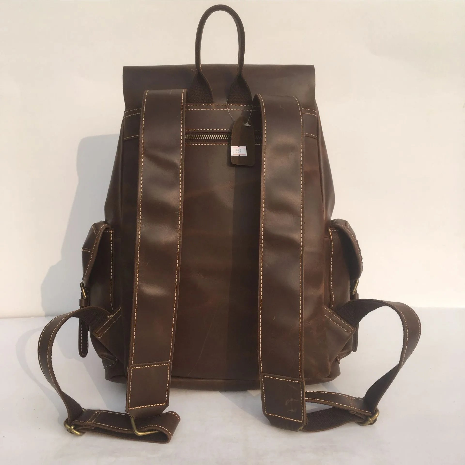Brown men's genuine cowhide leather backpack with air pillow belt straps.