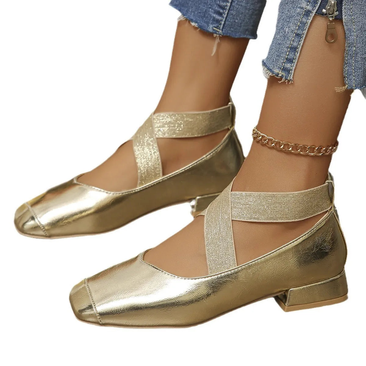 Gold slip-on evening pump with square toe and low rubber heel on a white background