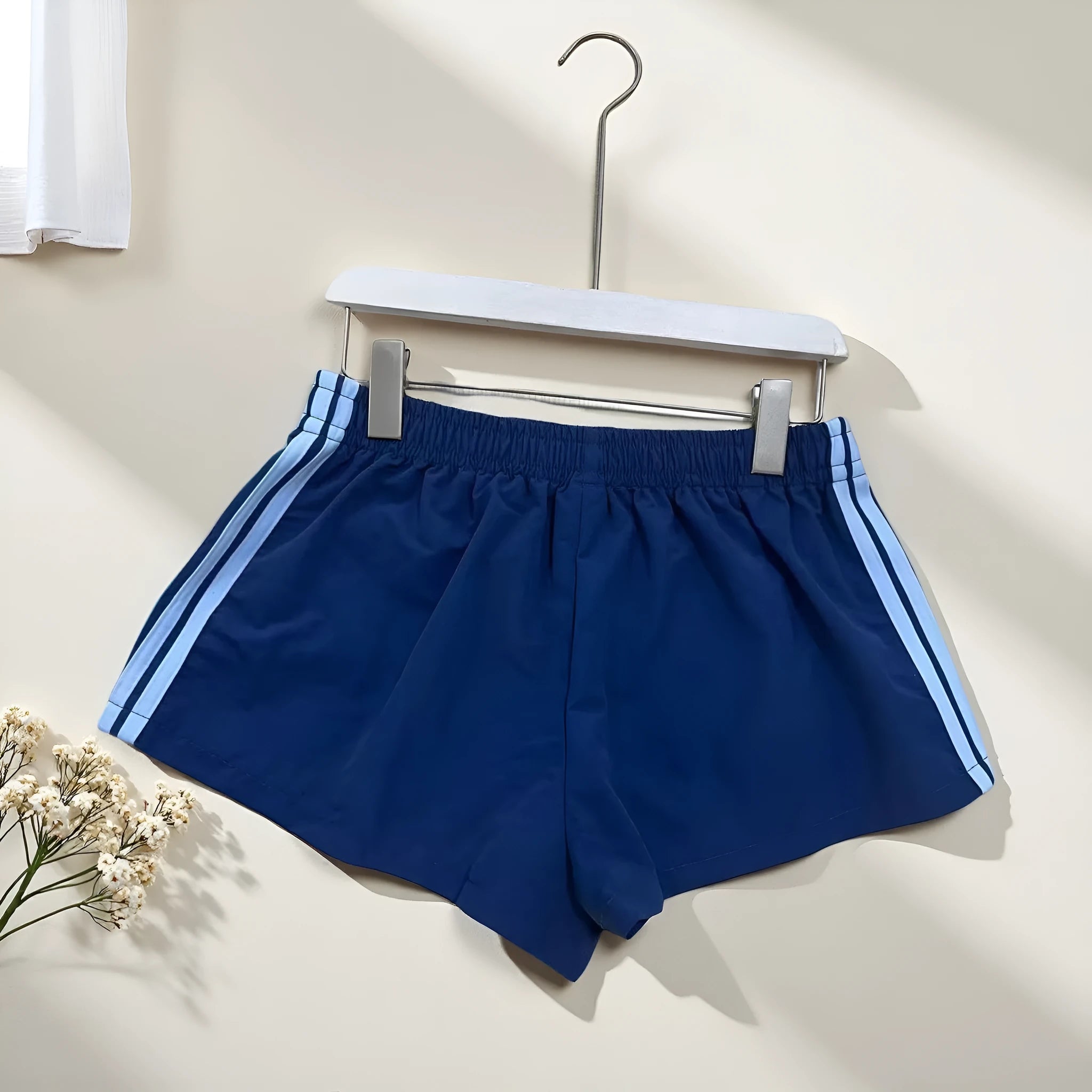 Navy blue men's high-waist nylon sports shorts on a white background