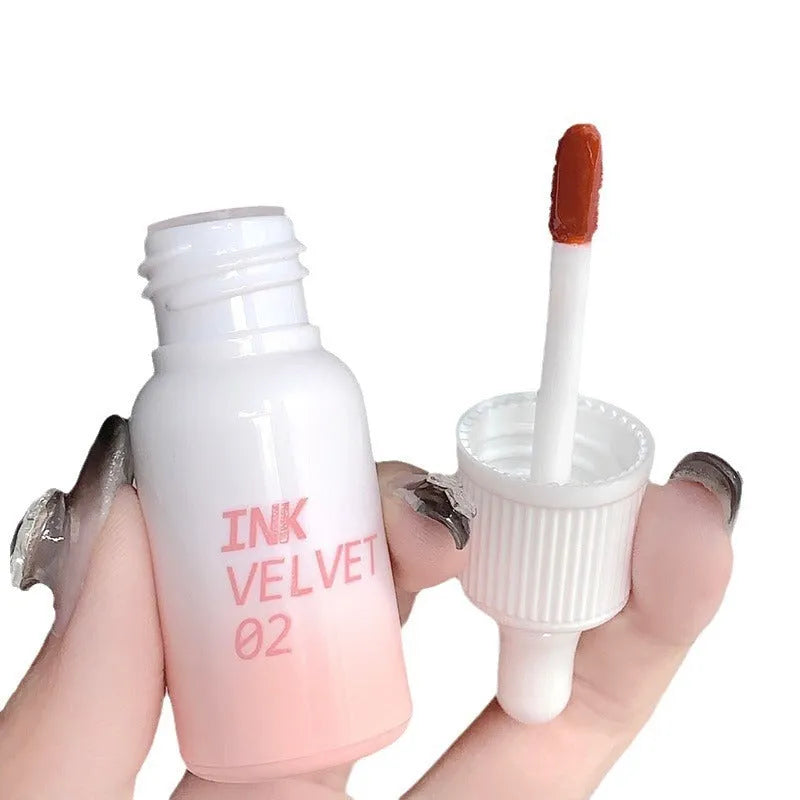 Mirror Lip Lacquer moisturising lip gloss tube in sheer shades on a plain background.