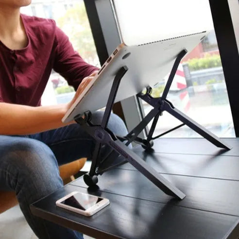 Black portable folding computer bracket shown at various heights up to 40cm with laptop