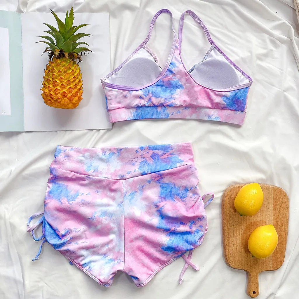 Tie-dye bikini shorts suit with push-up Brazilian top, nylon outer, polyester lining, light green or purple, sizes S to L.