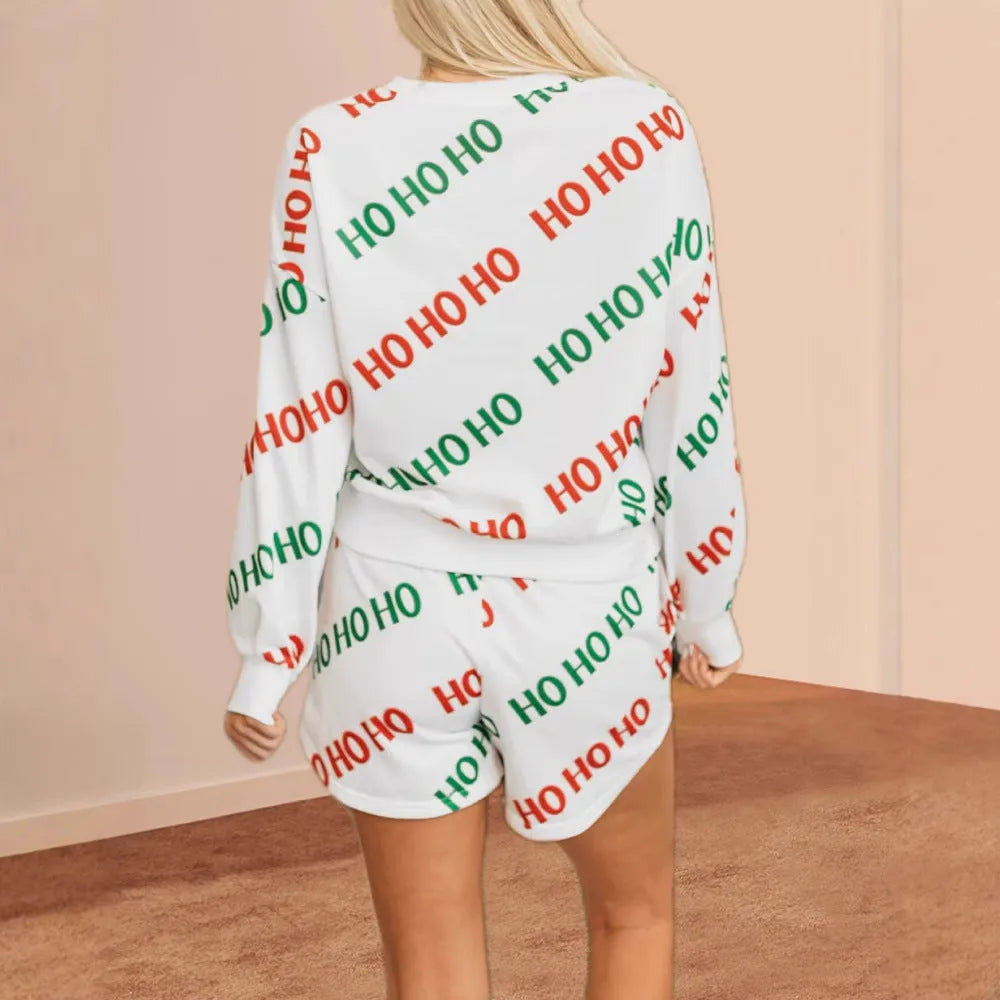 White women's two-piece suit with black letters print on the top and trousers, styled for street fashion.