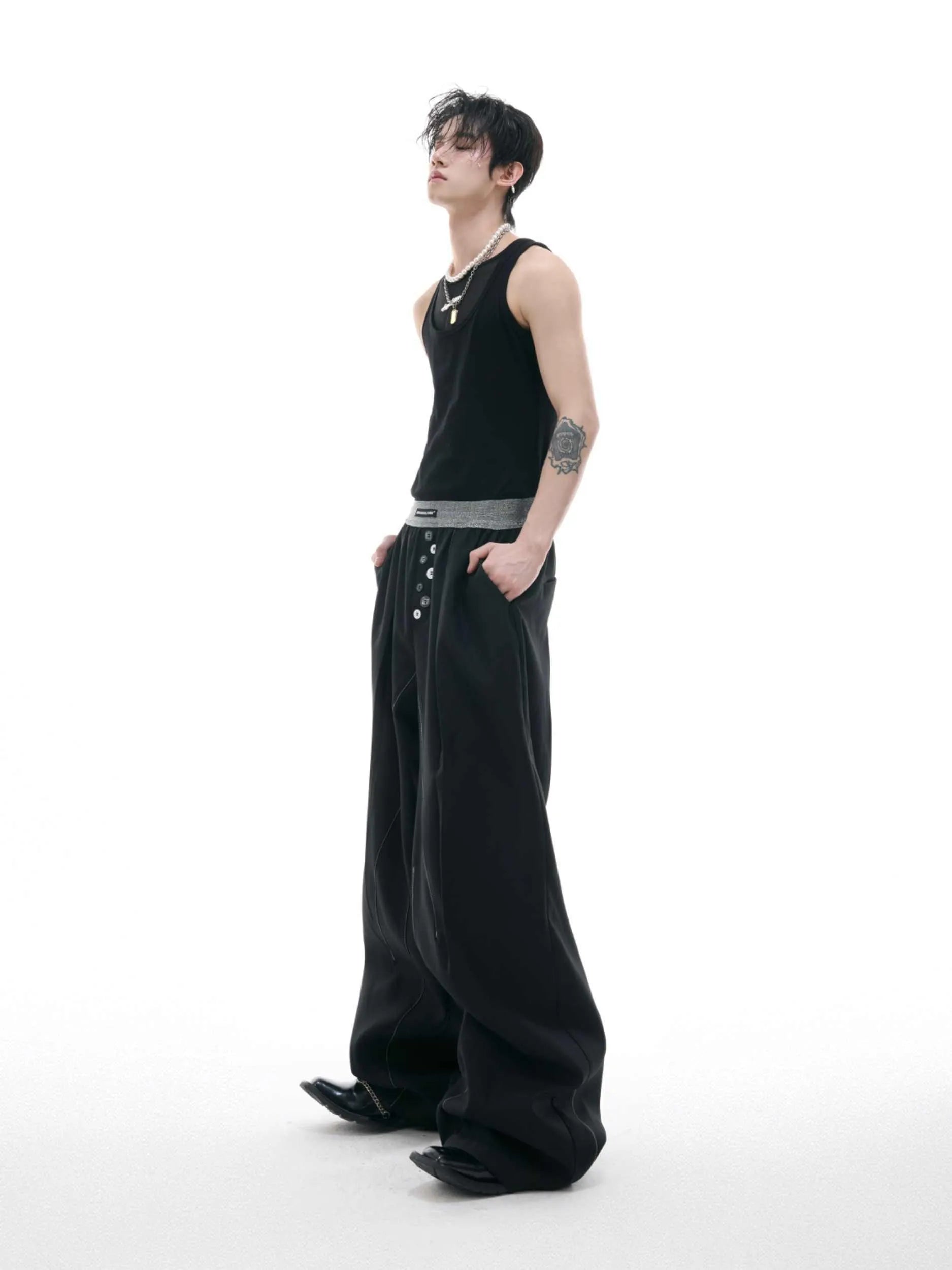 Straight-leg suit trousers in black with high waist and button-open line design, made from polyester-cotton blend.