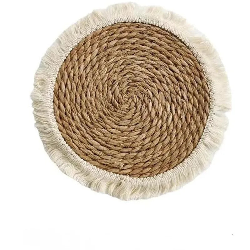 Round Japanese straw placemat with decorative tassels in natural papyrus colour, showing handwoven texture