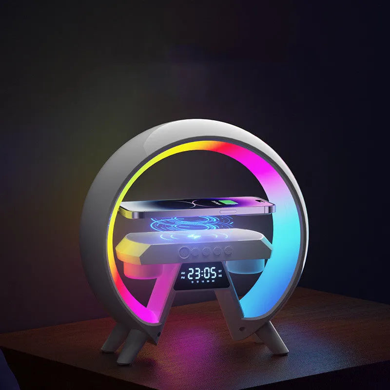 Black Bluetooth bedside speaker with wireless charging pad and LED clock display on white surface