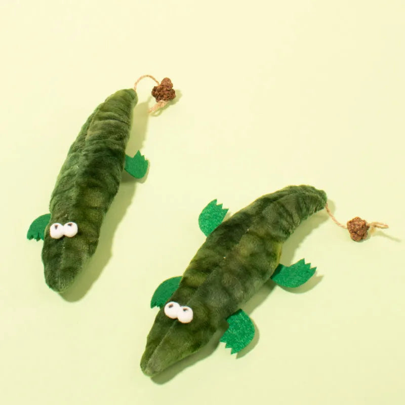 Green plush alligator catnip toy measuring 25cm long with detailed stitching and plant-based materials