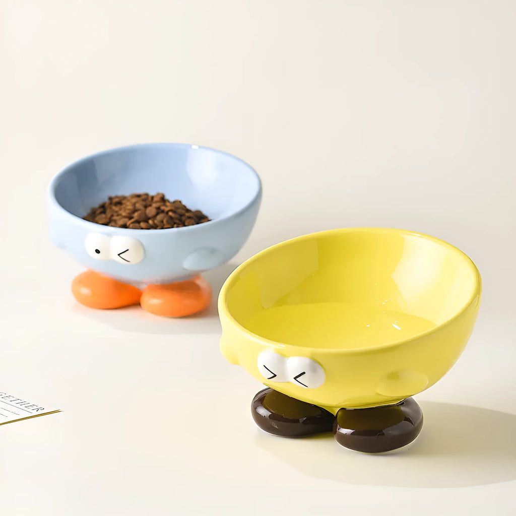 Blue slanted ceramic pet bowl for cats and dogs on a plain background.