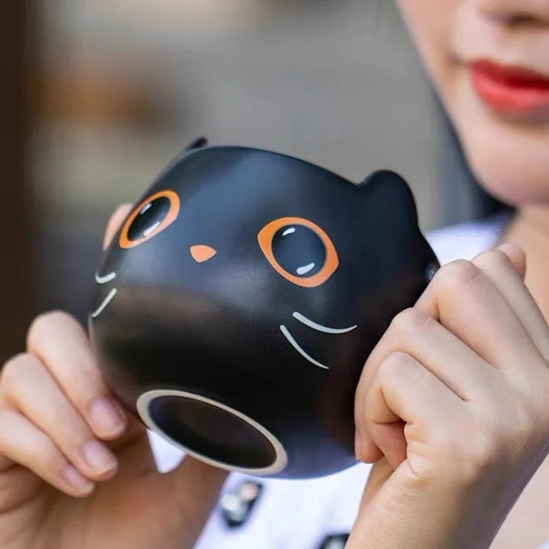 Black ceramic novelty mug with Halloween pumpkin, spoon couple, and cat design, 355ml capacity.