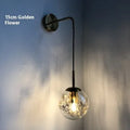 Glass bedside wall lamp with LED lighting in golden flower finish measuring 20cm diameter