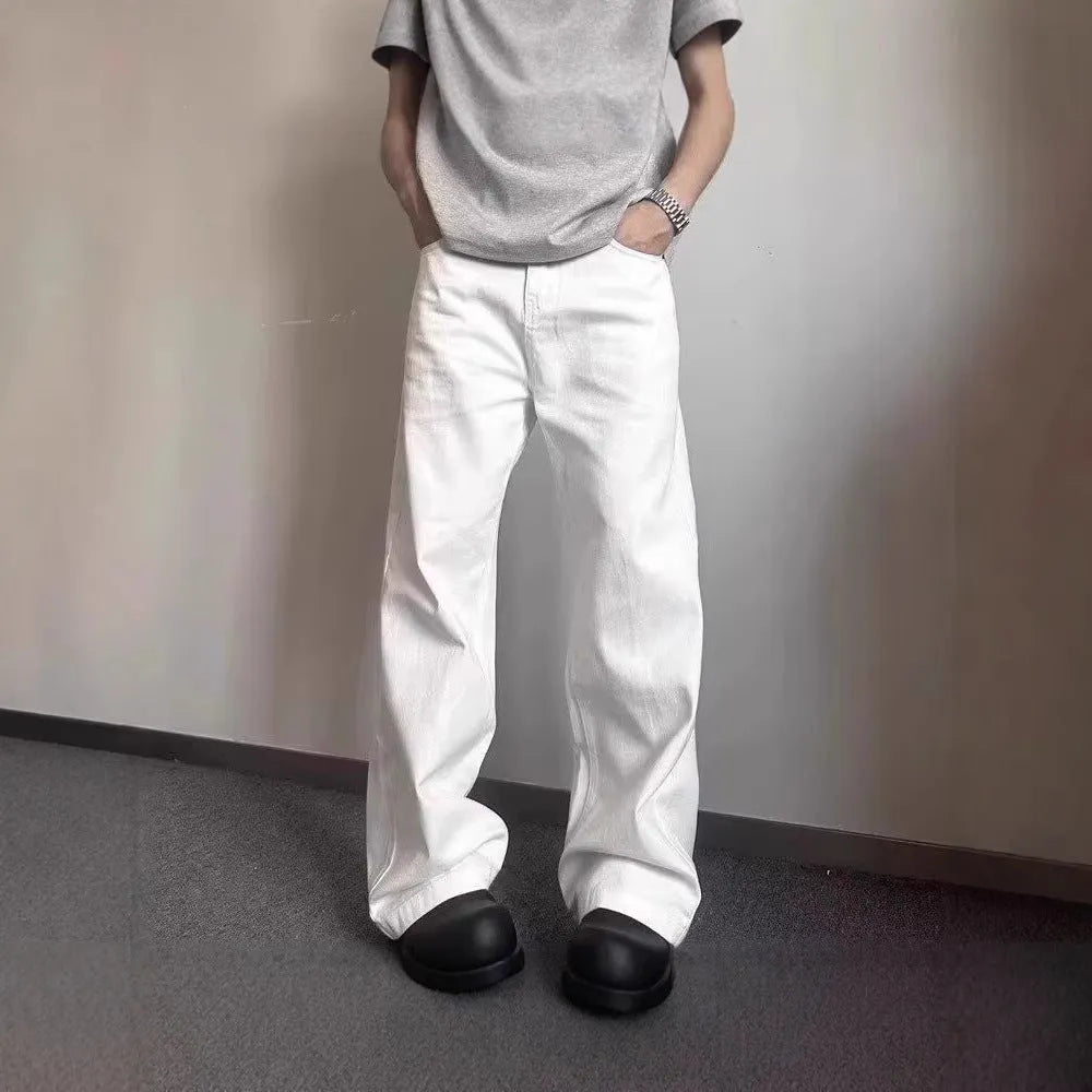 Men's white straight-leg jeans with a loose fit, made from 100% cotton denim, showing mid-waist and zipper fly.