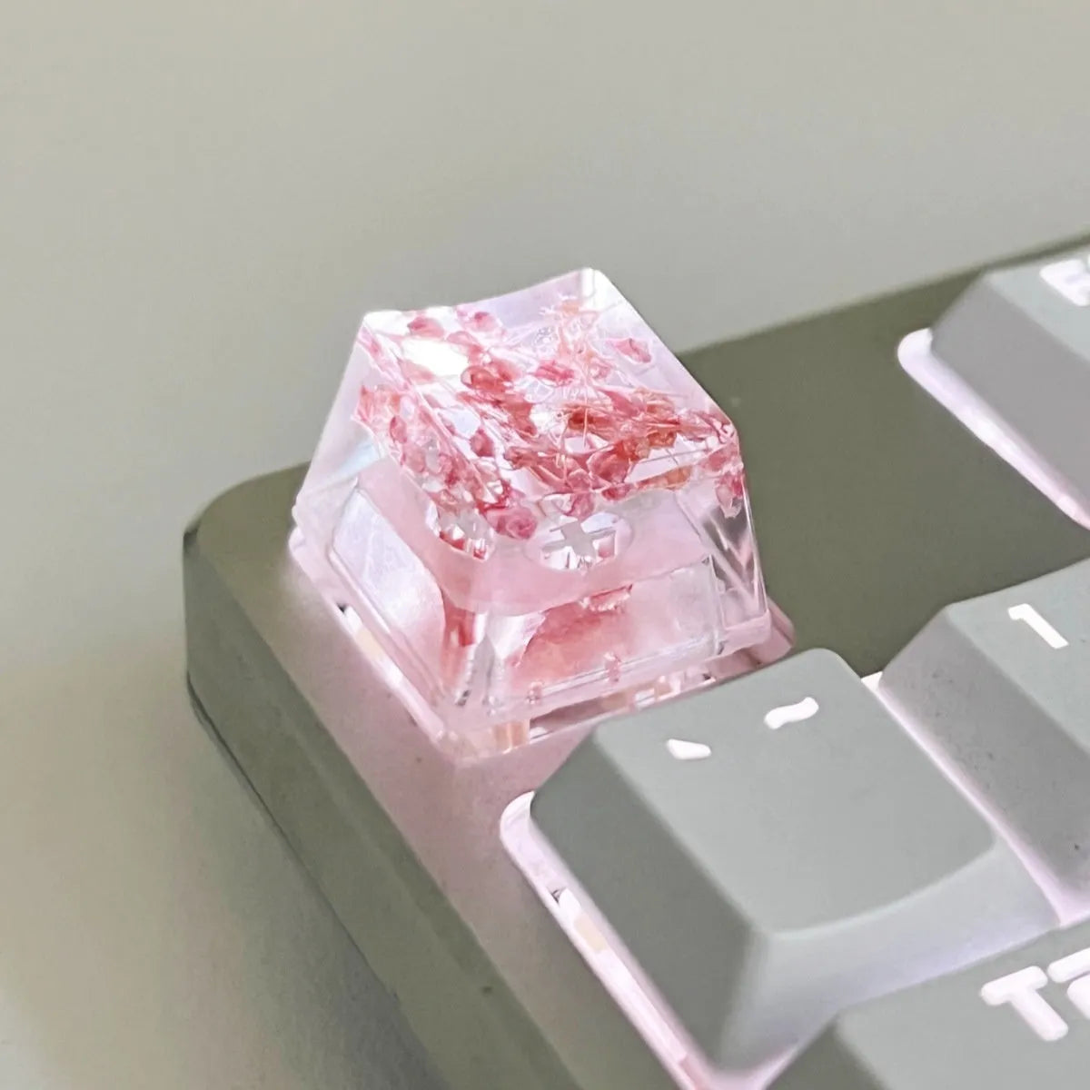 Translucent resin starry sky keycap with glitter particles measuring 1.8cm by 1.2cm