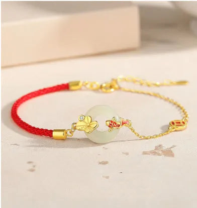 Gold electroplated 925 silver women's bracelet with koi and peace buckle design on adjustable red rope