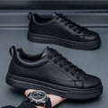 Men's low-top casual sneakers in black with white sole, showing round toe and flat heel design.