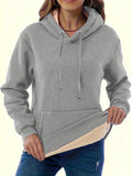 Women's black hooded sweater with a textured 3D pattern, loose fit, and front pockets.