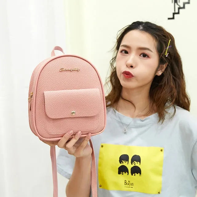 Women's small black backpack purse with adjustable straps showing 18.5cm length and zipper closure