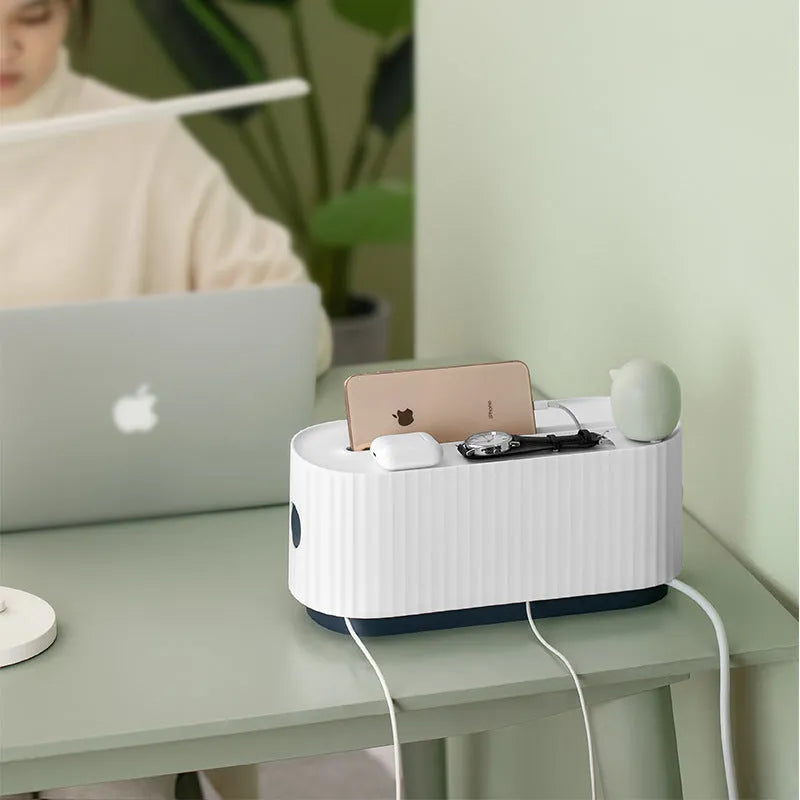 Blue and white power strip storage box with lid showing cable holes and internal phone slot