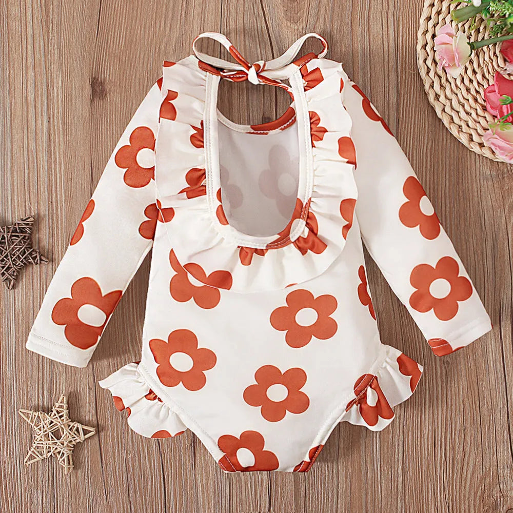 Girl's floral pattern open back swimsuit in polyester fabric showing crew neck design