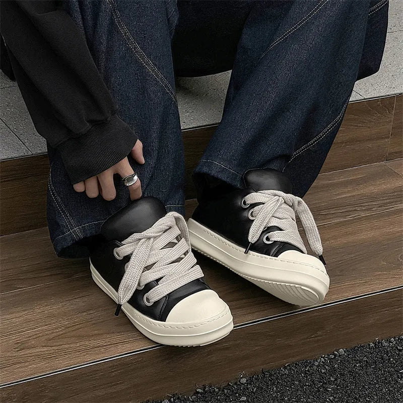Men's black leather slip-on shoes with flat sole and front lace-up