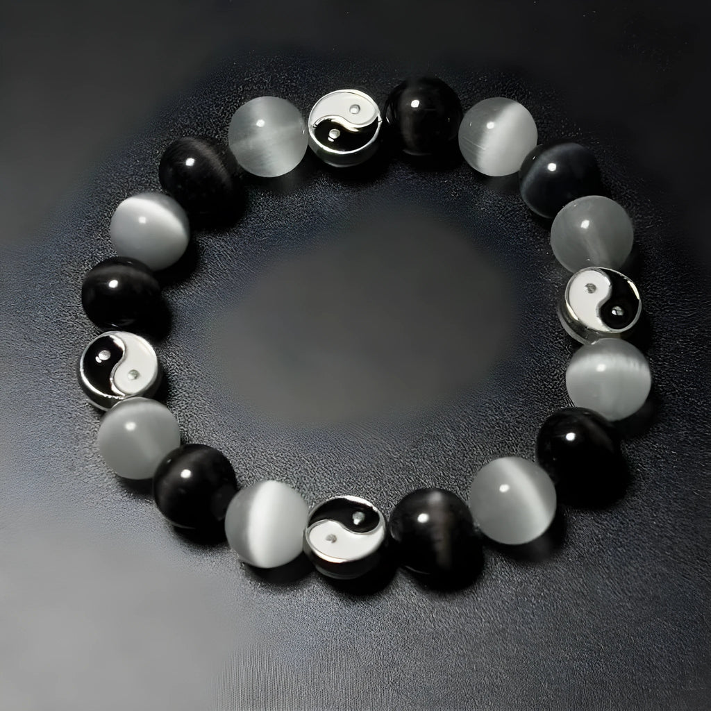 Close-up of a 10mm natural opal and black agate beaded bracelet in a Tai Chi style.