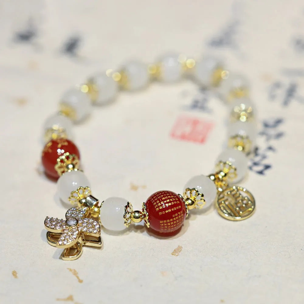Chinese style coloured glaze bracelet with glass safety lock charms and windmill bead design