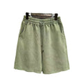 Man wearing navy blue distressed cotton casual shorts with a loose, straight-leg fit.
