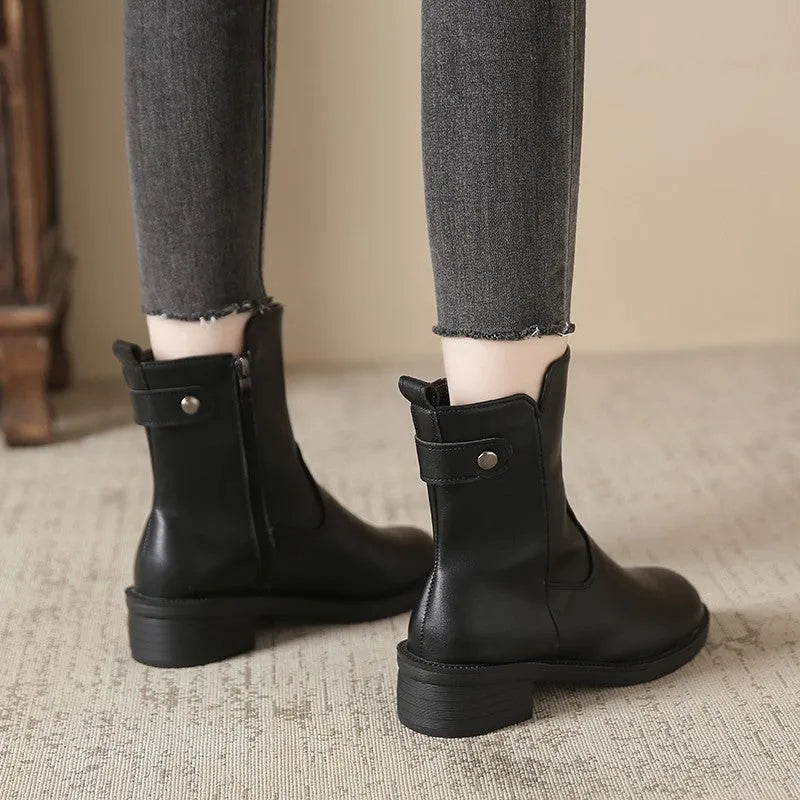 Black women's ankle boots with side zip, round toe, and a low rubber sole.