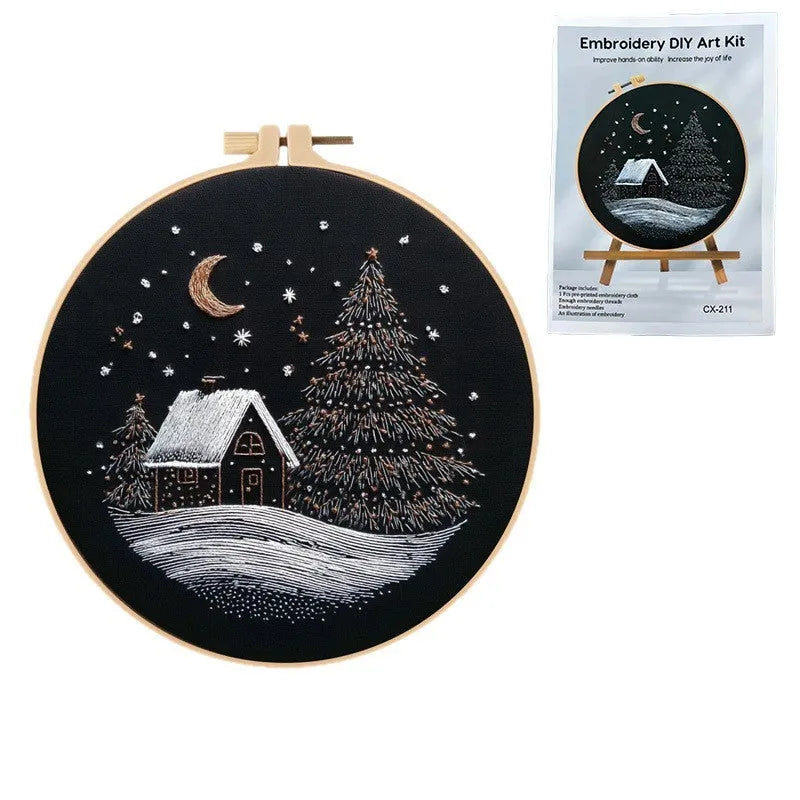 Christmas snow house embroidery kit showing 28cm square cotton linen fabric with printed landscape pattern.