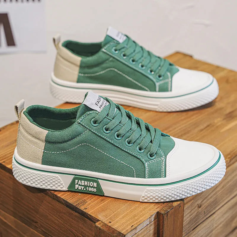 Men's low-top blue canvas shoes with round toe and white stitching on a soft PVC sole.