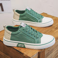 Men's low-top blue canvas shoes with round toe and white stitching on a soft PVC sole.