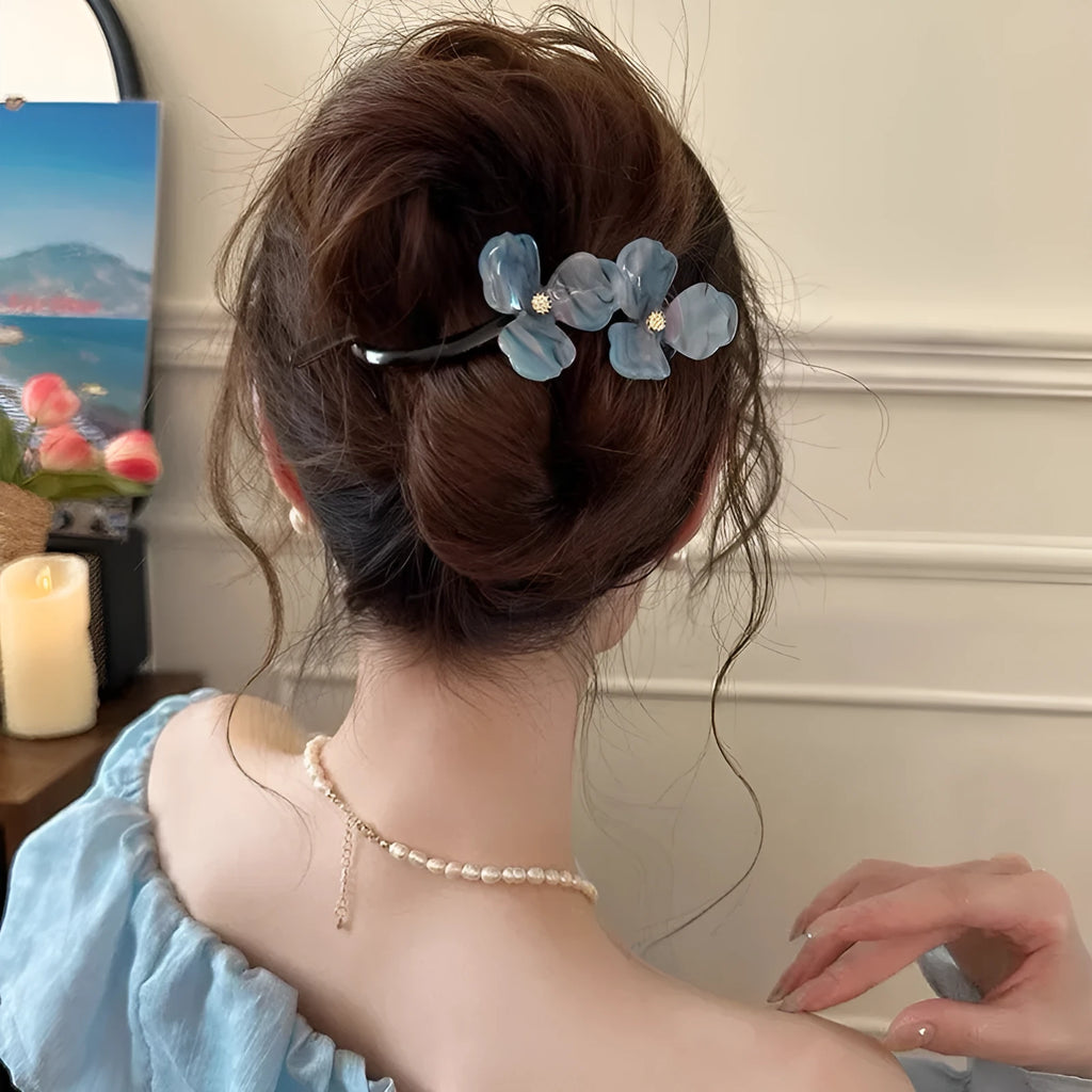 Retro flower hair bobby pin with coloured acrylic petals on a white background.