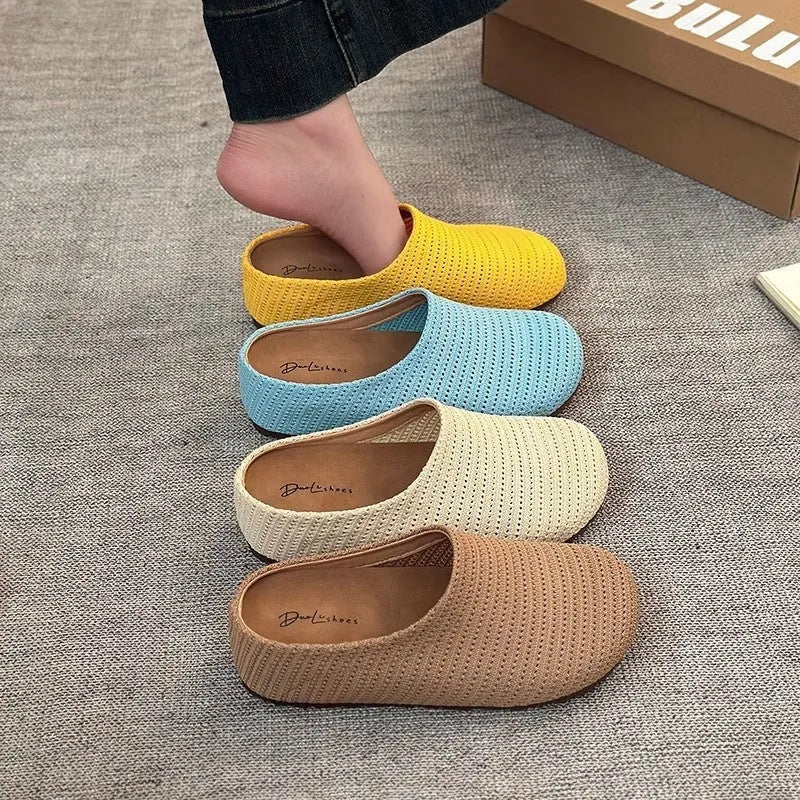 Women's blue cloth slippers with non-slip rubber soles and round toe design shown from side view