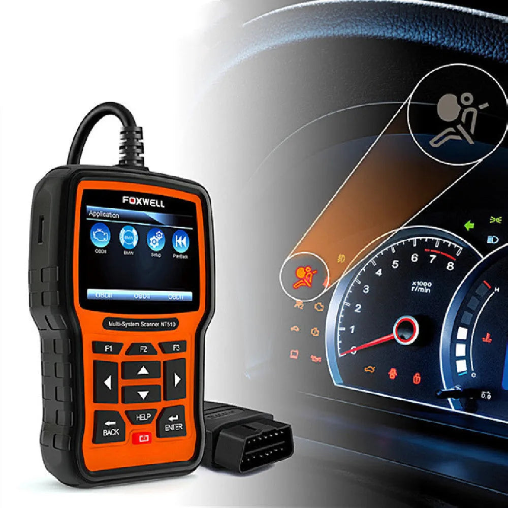 Foxwell NT510 orange and black automotive diagnostic tool with data cable on a workshop bench