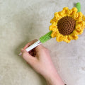 Hand-woven sunflower pen cover made from natural rattan and wheat straw in beige colour