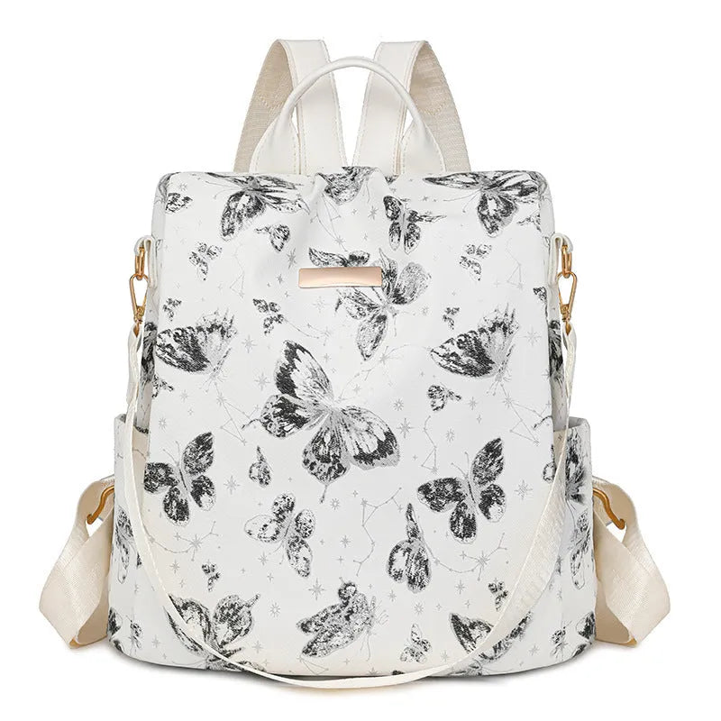 Butterfly printed black PU leather backpack with visible sewing lines and a physiological curve backplate.