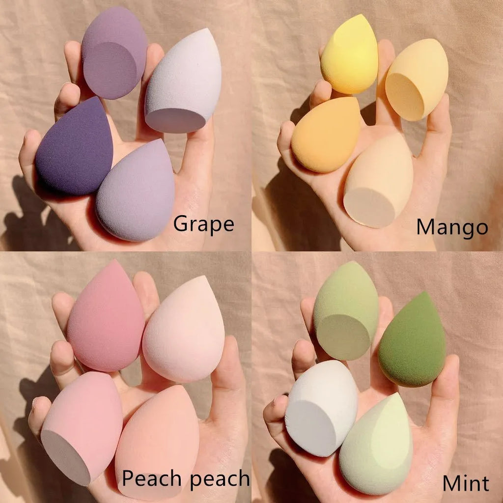 Four makeup egg sponges in grape, mango, mint, and peach colours, each 6cm in size