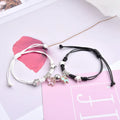 Pair of adjustable alloy bracelets with magnetic clasp showing detailed design of Crown and Clover styles