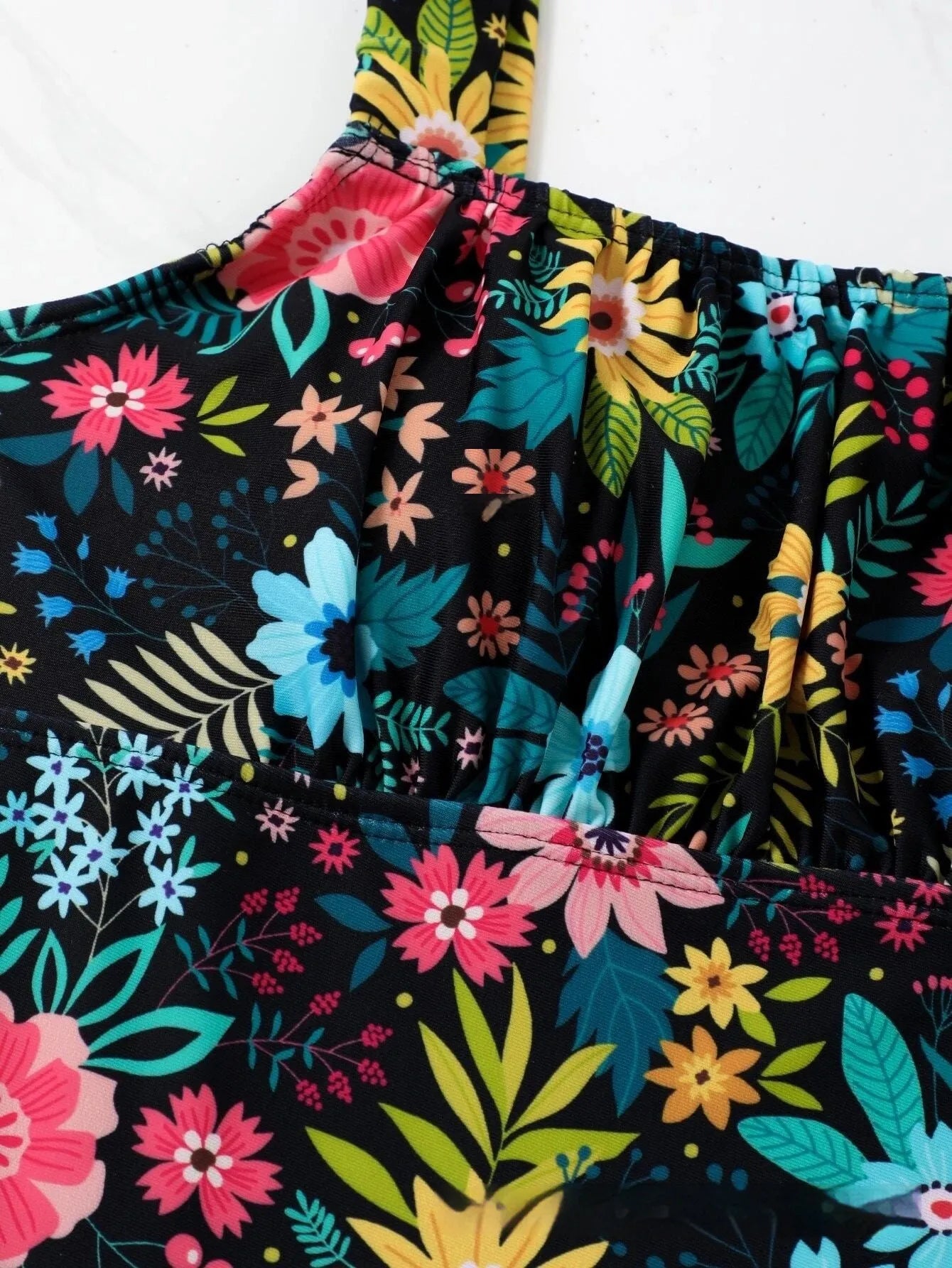 Women's floral print one-piece swimsuit with full-bed lining on a mannequin