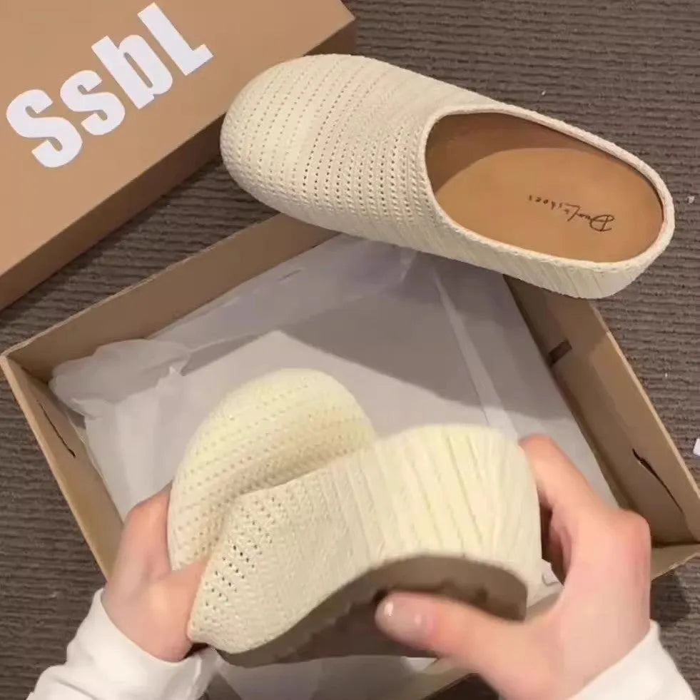 Women's blue cloth slippers with non-slip rubber soles and round toe design shown from side view