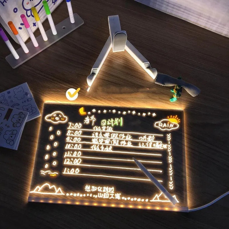 Acrylic DIY LED message board night light on a desk with handwritten drawing glowing softly.