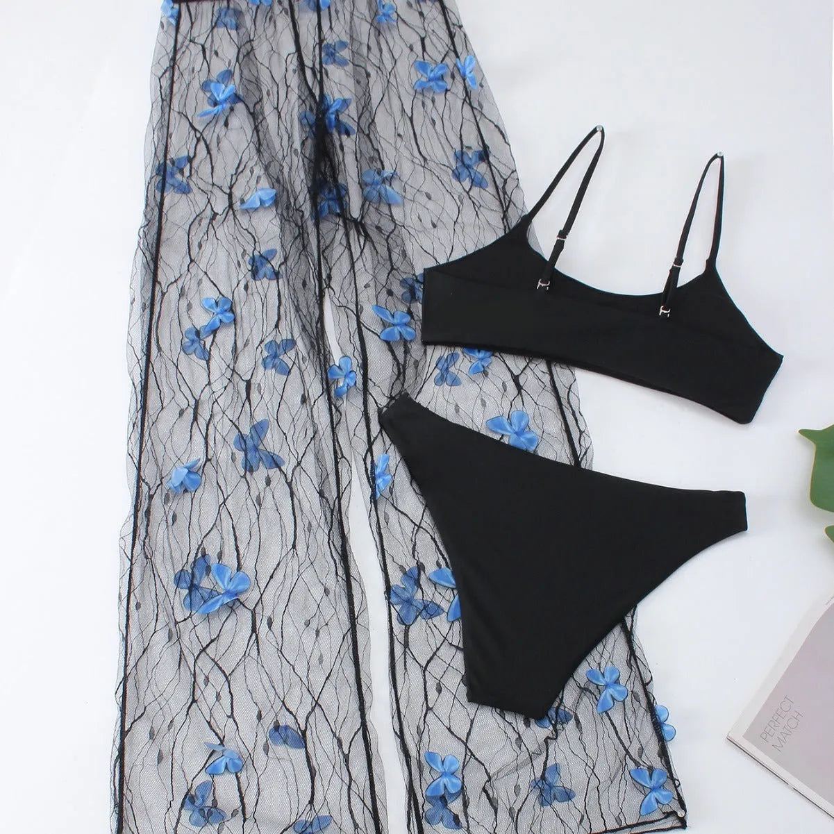 Black women's bikini set with butterfly embroidery showing top, underwear and pants pieces