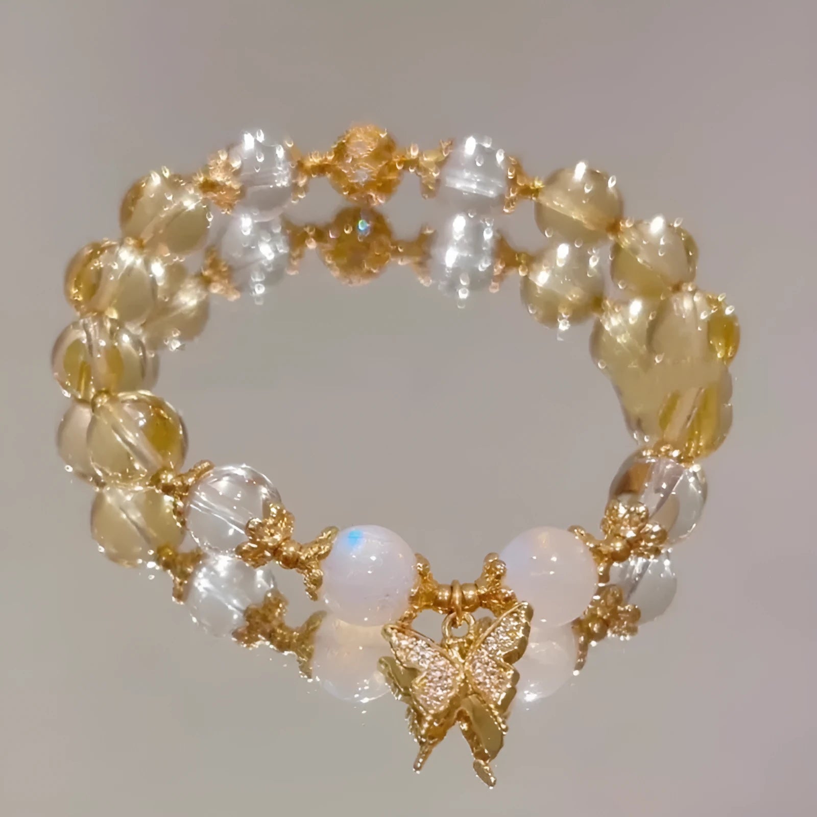 Moonstone white crystal bracelet with diamond-shaped beads and citrine butterfly charm in Chinese style design